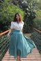 White top and emerald skirt